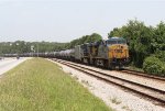 CSX 5438 and 5382 pause with a line of tank cars